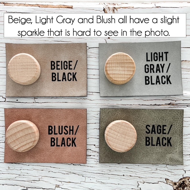 May include: Four rectangular leather samples with wooden knobs. The samples are beige, light grey, blush, and sage. Each sample has a corresponding text label in black: BEIGE/BLACK, LIGHT GRAY/BLACK, BLUSH/BLACK, and SAGE/BLACK. The text at the top says "Beige, Light Grey and Blush all have a slight sparkle that is hard to see in the photo."