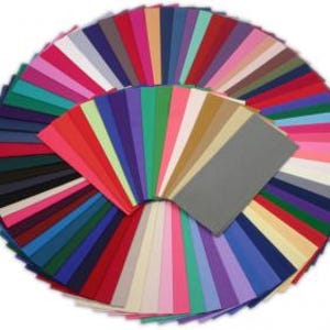 May include: A collection of 50 felt squares in various colors, including red, blue, green, yellow, pink, purple, orange, brown, black, and white. The squares are arranged in a fan shape.