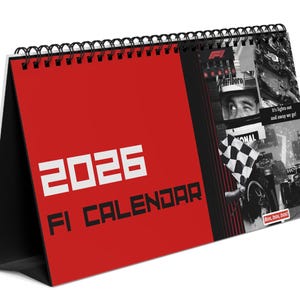 May include: A 2026 F1 calendar with a red cover and black spiral binding. The cover features the text "2026 FI CALENDAR" in white. The right side has black and white images of racing. The calendar is angled.