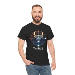 May include: Black t-shirt with a geometric design of a bull's head in a circle with the word "TAURUS" below it.