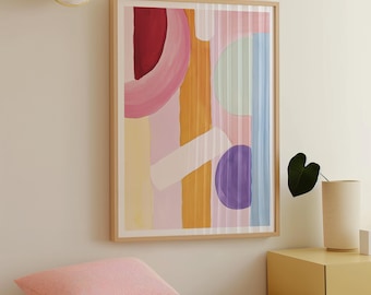 May include: Abstract art print with a colorful geometric design featuring pink, purple, yellow, and blue shapes. The print is framed in a natural wood frame.