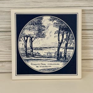 May include: Square ceramic tile featuring a black and white illustration of a park scene with trees and a body of water. The text "Mosquito Park Overlooking The Mississippi" is printed at the bottom of the image. The tile has a white border.
