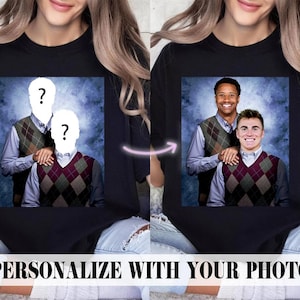 May include: A black t-shirt with a photo of two people wearing sweaters. The faces of the people are blurred out and replaced with question marks. The text "PERSONALIZE WITH YOUR PHOTO" is at the bottom of the image.