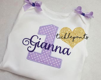 For all ages and sizes - Girl's 1st birthday shirt - Name and age - Shown in lavender and purple - Colors can be changed