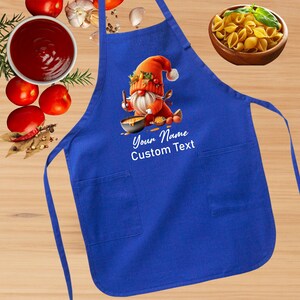 May include: Blue kitchen apron with a gnome cooking in a pot. The apron has two pockets and the text "Your Name Custom Text".