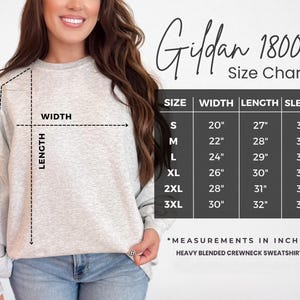 A woman wearing a Gildan 18000 crew neck sweatshirt is shown in the image, with a size chart and measurements for different sizes.