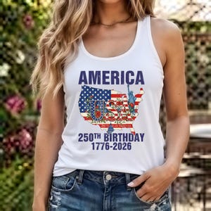 May include: A white tank top featuring a graphic of the United States map filled with the American flag, red roses, and the Statue of Liberty. The text reads AMERICA USA 250 YEARS OF FREEDOM 250TH BIRTHDAY 1776-2026 in blue and red lettering.