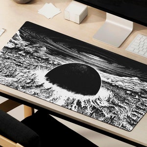 May include: Black and white mouse mat featuring a graphic of a large, black sphere surrounded by swirling, white lines. The sphere appears to be sinking into a sea of white waves.