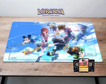 May include: A blue and white playmat with a colorful illustration of characters from the Kingdom Hearts video game series. The playmat features Mickey Mouse, Sora, Riku, and Kairi. The playmat is designed for use with the Lorcana Trading Card Game.