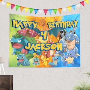 May include: A colourful birthday banner featuring Pokemon characters. The banner is blue, green, yellow, and orange. It says "Happy Birthday" and "Jackson" with the number "4" in the centre.