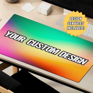 May include: A colorful gradient mousepad with the text "YOUR CUSTOM DESIGN" in black. A yellow star sticker with the text "DESIGN SERVICES INCLUDED!" is on the desk.