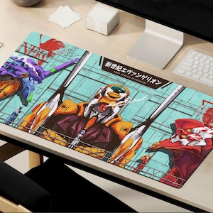 May include: A colourful mouse mat featuring a graphic design of characters from the anime series Neon Genesis Evangelion. The mouse mat has a blue, green and yellow background with red, white and black characters. The text "新世紀エヴァンゲリオン" is written in Japanese on the mouse mat.