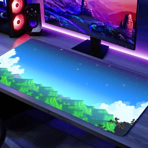 May include: A blue and green gaming mouse pad with a starry night sky and a landscape of rolling hills.