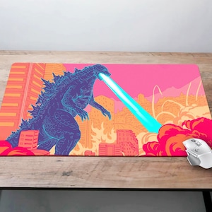 May include: A blue and purple Godzilla-like monster with a blue laser beam shooting from its mouth. The monster is standing in front of a city skyline with red, orange, and yellow buildings. The background is a pink and orange sunset.