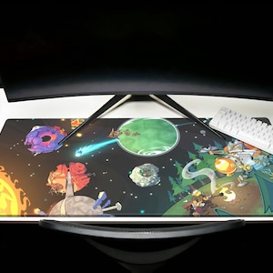 May include: A colourful space-themed mouse mat featuring a variety of planets, stars, and characters. The mouse mat features a bright yellow sun, a green planet with a swirling pattern, and a purple planet with a ring. There are also several cartoon characters, including a robot, a creature with a large head, and a creature with a long tail.