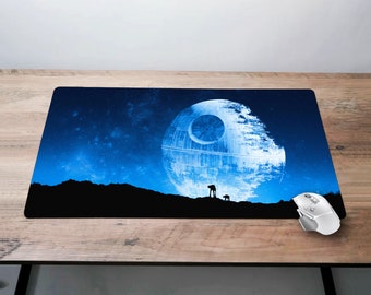 May include: A rectangular mousepad featuring a Death Star design against a starry blue sky. The image includes silhouettes of figures and a white computer mouse on a wooden surface.