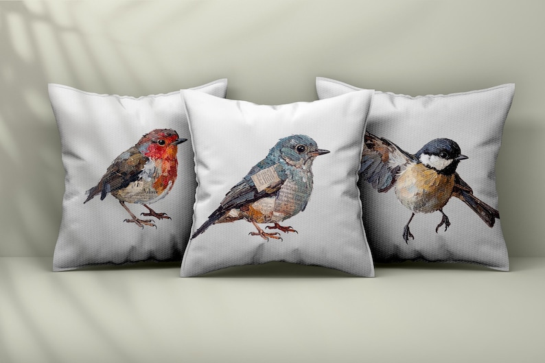 May include: Three square white throw pillows featuring detailed illustrations of birds. The left pillow shows a robin, the center pillow displays a blue-toned bird, and the right pillow depicts a black, white, and brown bird with wings spread.