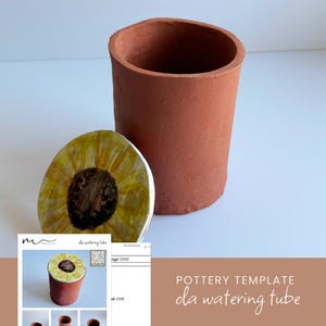 May include: A cylindrical terracotta watering tube with a matte finish and a separate circular lid featuring a hand-painted yellow sunflower design with a dark brown center. The object is displayed alongside a printed pottery template document.