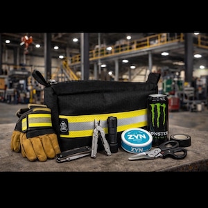 May include: A black bag with a yellow and reflective stripe, alongside work gloves, a can of Monster Energy, and various tools. The tools include a multi-tool, flashlight, knife, scissors, tape, and a can of ZYN nicotine pouches.