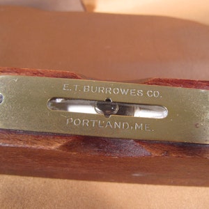 May include: A brass level with the inscription "E.T. BURROWES CO. PORTLAND, ME."