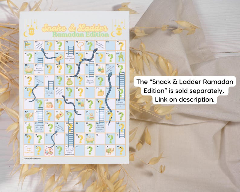 May include: A blue and yellow game board with a snake and ladder design. The board is titled "Snake & Ladder Ramadan Edition".