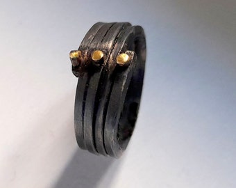 Oxidized sterling silver wide ring with gold dots.