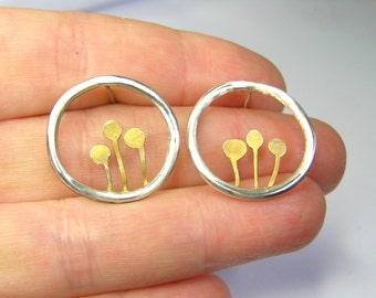 Sterling silver circles with gold plated little trees post earrings .