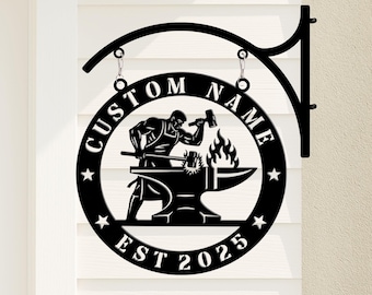 May include: Black metal sign featuring a blacksmith design. The round sign has the words "CUSTOM NAME" and "EST 2025". A blacksmith is shown working at an anvil. The sign is suspended from a black metal bracket.