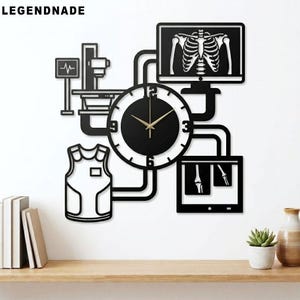 May include: Black metal wall clock with a medical theme, featuring a clock face, an X-ray image, and a medical vest. The clock has gold hands and the text "LEGENDNADE" at the top.