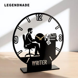 May include: Black desk clock with a writer silhouette, featuring a clock face with the numbers 12, 3, and 9. The clock hands are gold. The word "WRITER" is at the base. The brand name "LEGENDNADE" is at the top.