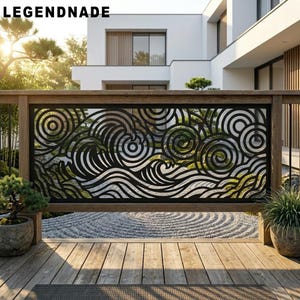 May include: A black metal railing panel featuring a laser-cut design of stylized ocean waves and swirling circular patterns. The rectangular panel is mounted within a wooden frame, positioned on a wooden deck with potted plants on each side.