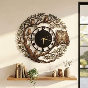 May include: A circular wall clock featuring a brown tree branch frame with green leaves and five owls perched on the branches. The clock face is black with white numbers from 1 to 12 and gold-colored hour, minute, and second hands.