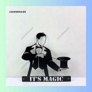 May include: Black metal wall art depicting a magician pulling a top hat from thin air. The art features the text "IT'S MAGIC".