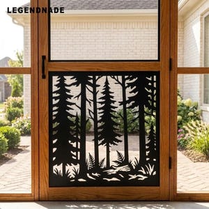 May include: A black metal screen insert featuring a laser-cut forest silhouette with pine trees and ferns, installed within a wooden door frame. The text LEGENDNADE is visible in the upper left corner of the screen panel.