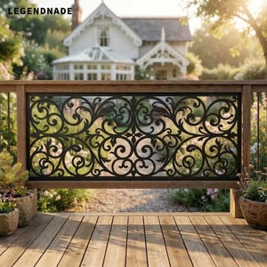May include: A black metal railing panel featuring an intricate scrollwork design with symmetrical floral-inspired patterns. The rectangular panel is framed by a wooden structure and displays the text LEGENDNADE in the top left corner.