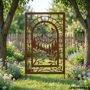 May include: A rectangular, rust-coloured metal garden screen featuring a cut-out design of a mountain landscape, trees, and a bird on a branch. The screen is framed by an arch and foliage. It is set in a garden with a wooden fence in the background.