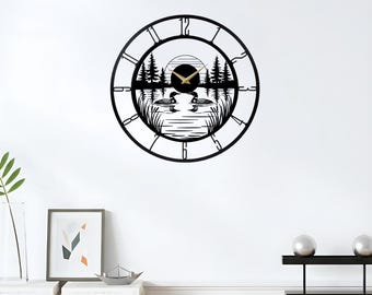 May include: Black metal wall clock with a nature scene featuring two loons on a lake, trees, and a sun. The clock face has a circular design with Roman numerals and the brand name "LEGENDNADE" at the top.
