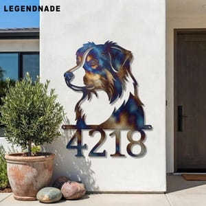 May include: A metal wall sign featuring a silhouette of an Australian Shepherd dog head with a heat-treated iridescent finish in shades of blue, gold, and brown, positioned above the house numbers 4218 in a bold, dark metal font.