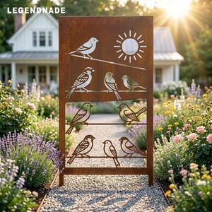 May include: A rectangular, rust-colored metal garden screen featuring laser-cut designs of birds perched on horizontal lines and a sun motif. The text LEGENDNADE is visible in the top left corner. The screen has a weathered, oxidized finish.