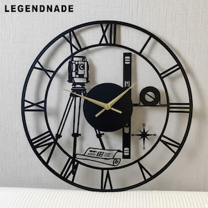 May include: Black metal wall clock with Roman numerals and gold clock hands. The clock features a surveyor's transit, level, and compass rose design. The word "LEGENDNADE" is printed at the top.