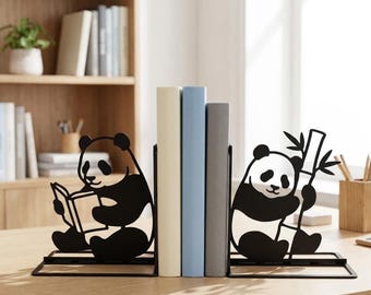 May include: A pair of black metal bookends featuring panda silhouettes. One panda is depicted sitting and reading an open book, while the other panda is sitting and holding a stalk of bamboo. The bookends support three upright books.
