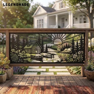 May include: A black metal decorative panel featuring a laser-cut landscape scene with a cabin, a canoe on water, pine trees, and a sunburst design. The text LEGENDNADE is visible in the upper left corner of the rectangular outdoor railing insert.