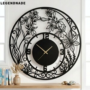 May include: Black, round wall clock with a floral design. The clock features a black face with gold hands and a decorative outer ring with cut-out floral and leaf patterns. The brand name "LEGENDNADE" is in the top left corner.