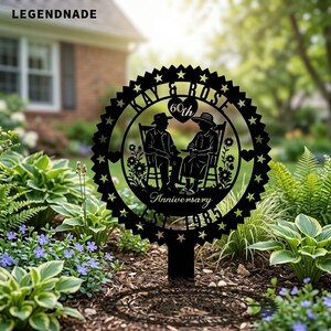 May include: Black metal garden stake with a circular design featuring the text "Kay & Rose 60th Anniversary EST 1965". The design includes silhouettes of a couple in rocking chairs, surrounded by stars and floral accents.