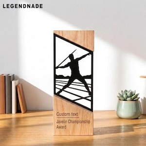 May include: A rectangular wooden award trophy featuring a black metal cutout silhouette of an athlete throwing a javelin. The base includes the printed text Custom text and Javelin Championship Award in a clean, dark sans-serif font.