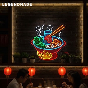 May include: A neon sign in the shape of a hot pot, with red, blue, green, and yellow lights. The sign is mounted on a dark brick wall. The word "LEGENDNADE" is above the sign. The image shows people eating at a table with red lanterns.
