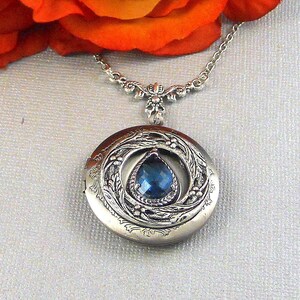 Sapphire navy blue Victorian Steampunk Locket is 30 inches long.  Feminine antique silver locket is decorated with Victorian style antique silver floral frame. Free photo service.