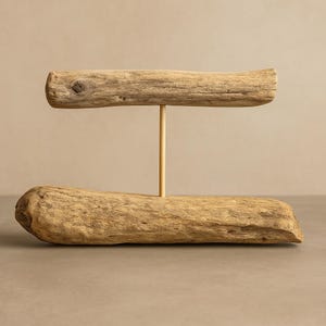 Driftwood bracelet holder standing upright on a base, with a horizontal wood branch supported by a vertical post for displaying bracelets.
