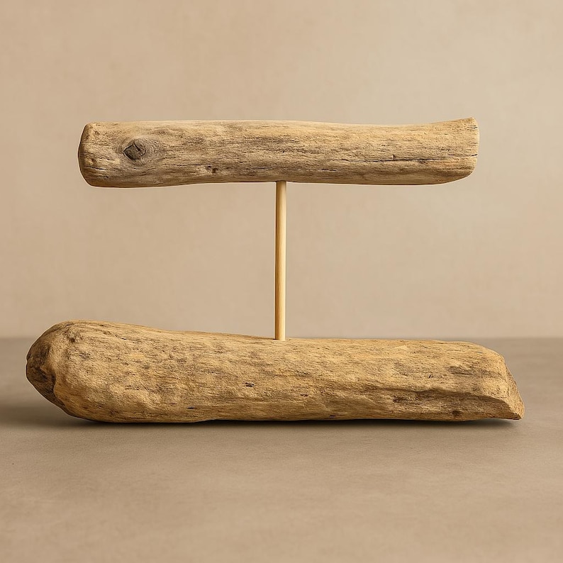 Driftwood bracelet holder standing upright on a base, with a horizontal wood branch supported by a vertical post for displaying bracelets.