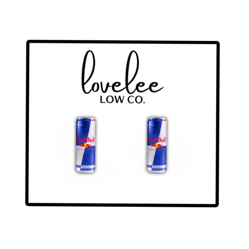 May include: Two blue and silver Red Bull energy drink cans positioned side by side below the black text 'lovelee LOW CO.' on a white background. The cans feature the iconic red bull logo and branding, presented in a clean, centered layout.